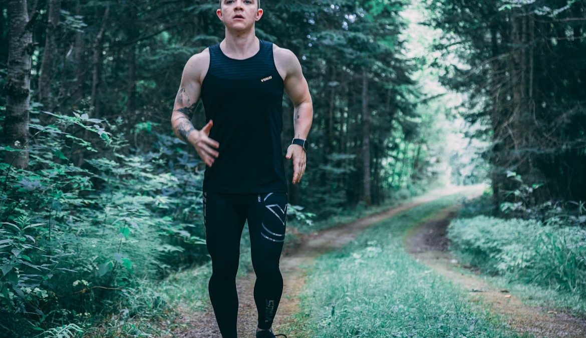 man walking on forest trail